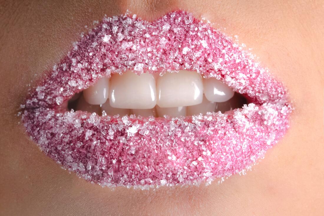 A picture of a woman wearing pink, frosted lipstick.