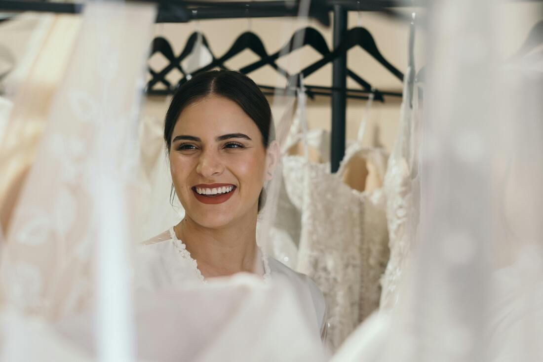 A woman in her bridal dress smiling