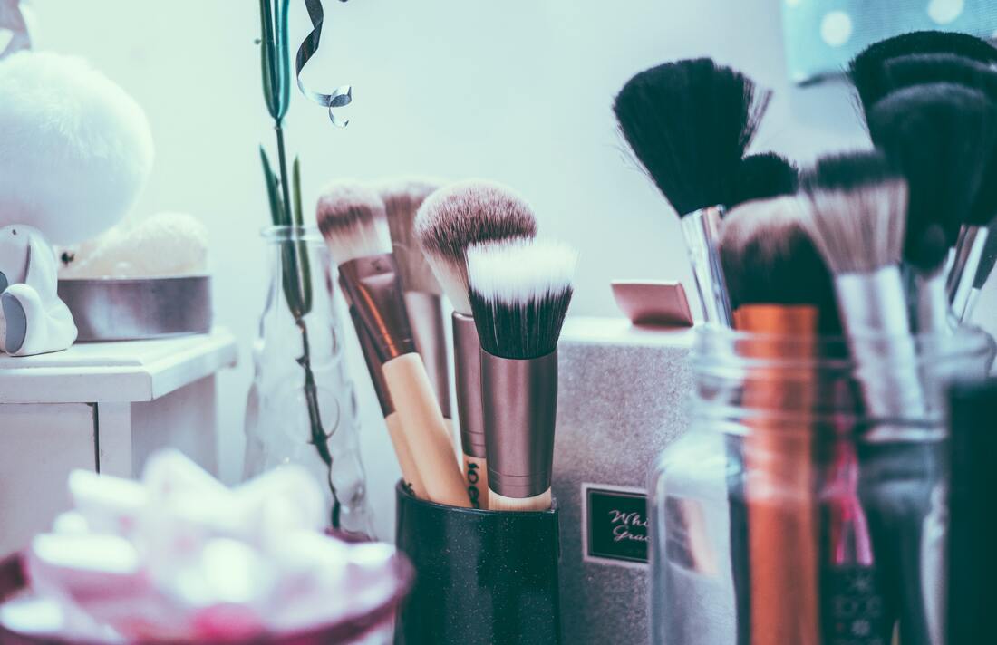 A counter with makeup brushes, sponges, and other accessories for getting makeup done perfectly.